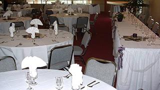 Image of tables and place settings set up for a wedding reception in Macey Center.